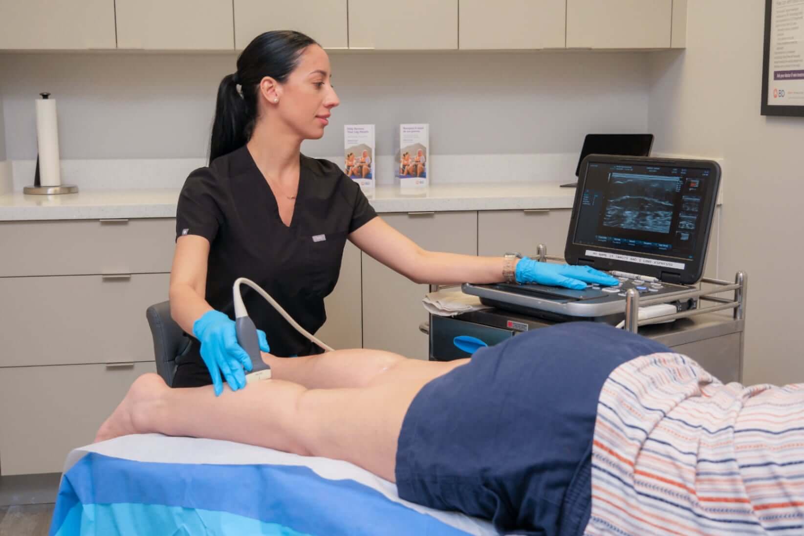 Miami Vein Institute clinician performing a vein ultrasound evaluation in office